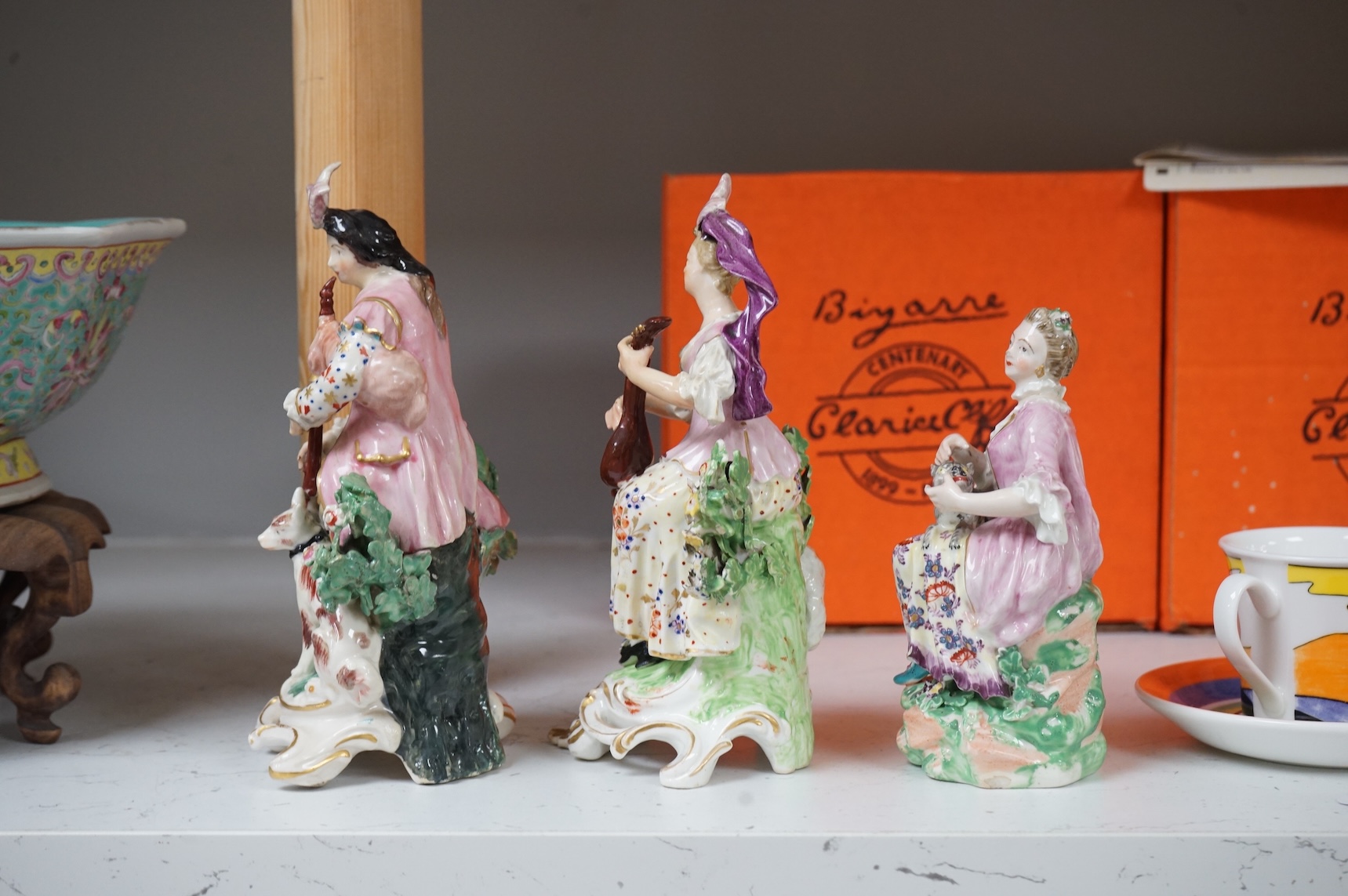 A pair of Derby porcelain figures of musicians, and another of a lady and cat, late 18th century, largest 18cm high